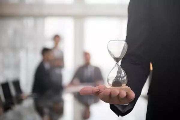 businessman-holding-hour-glass-signifies-importanc